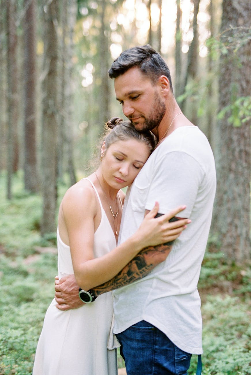 portrait of couple hugging in forest