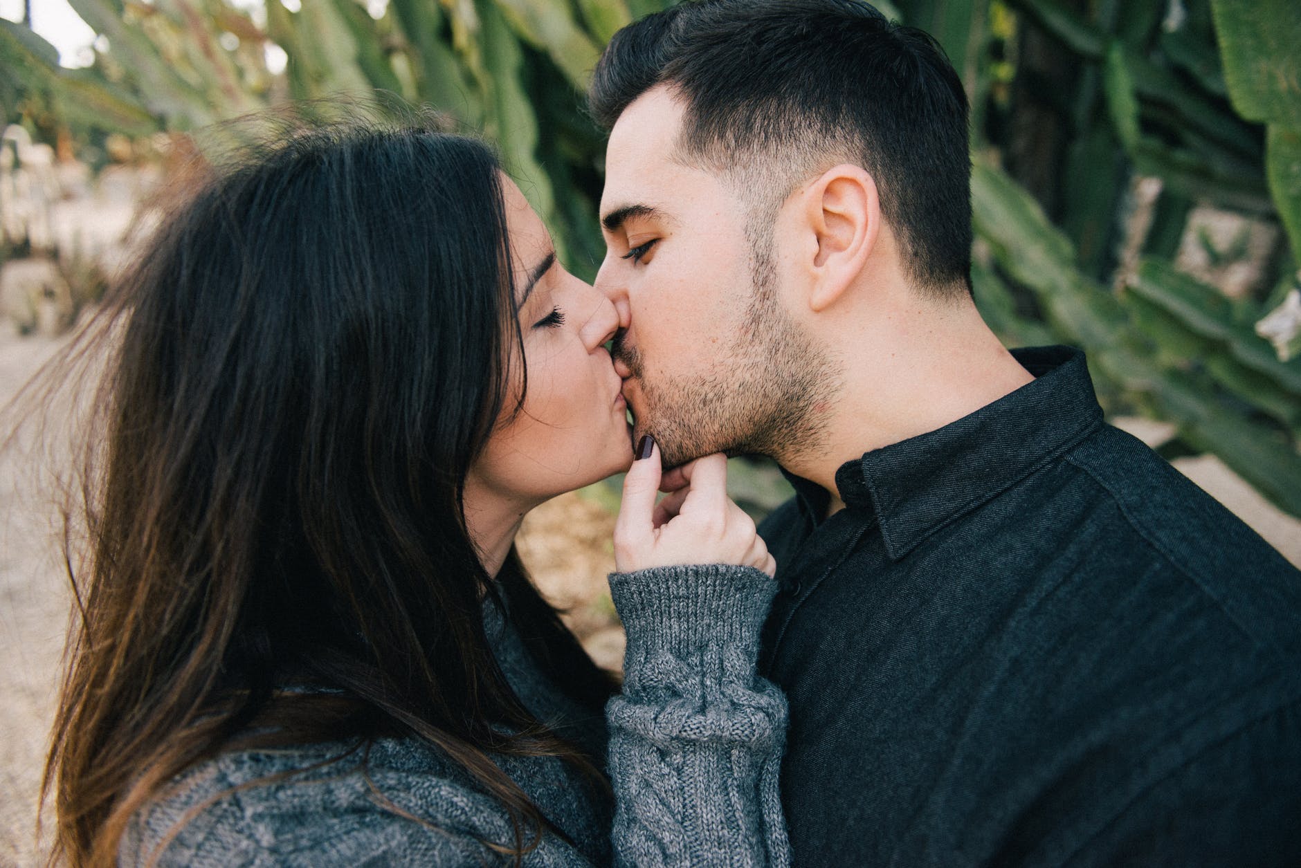 photo of woman kissing man